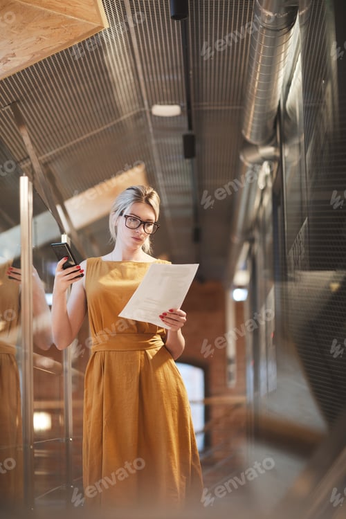 Preview: Businesswoman reading a document