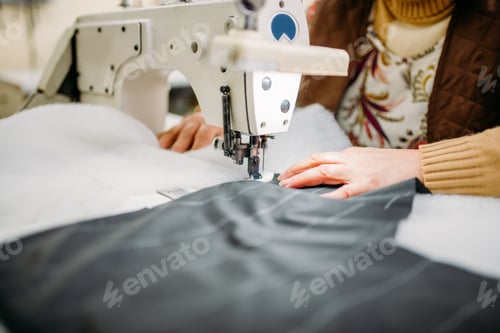 Preview: Seamstress sews fabrics on a sewing machine