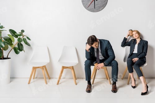 Preview: bored tired business people waiting on chairs in line