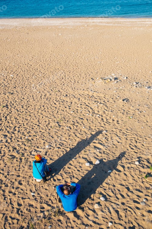 Preview: Sitting hikers on the sand beach in Cirali