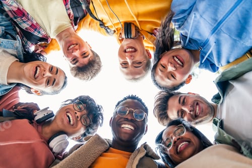 Preview: Happy diverse students having fun hugging together