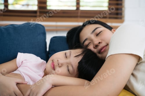 Preview: Asian family mom and daughter napping sleeping on sofa