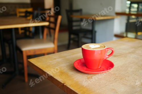 Preview: a cup of late coffee with flower shape design on top at cafe
