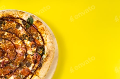 Preview: Delicious large pizza with bacon and spinach on a yellow background