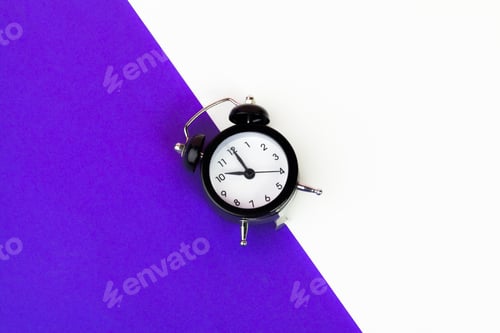 Preview: Vintage black alarm clock on lilac background