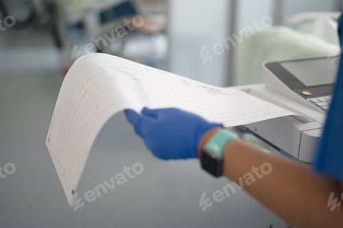 Preview: Healthcare professional holding ekg paper with heart data