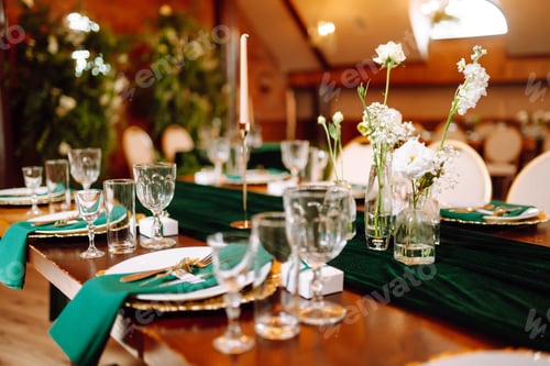 Preview: Floral decorations on the banquet table in the restaurant. Wedding, birthday, party, event concept.