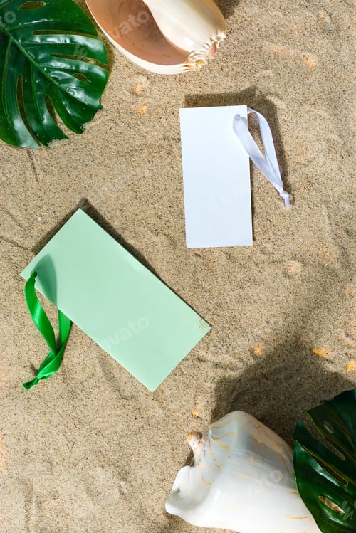 Preview: Mock up empty invitation cards on a sand beach