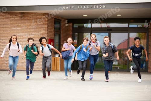 Preview: Group Of High School Students Running Out Of School Buildings Towards Camera At The End Of Class