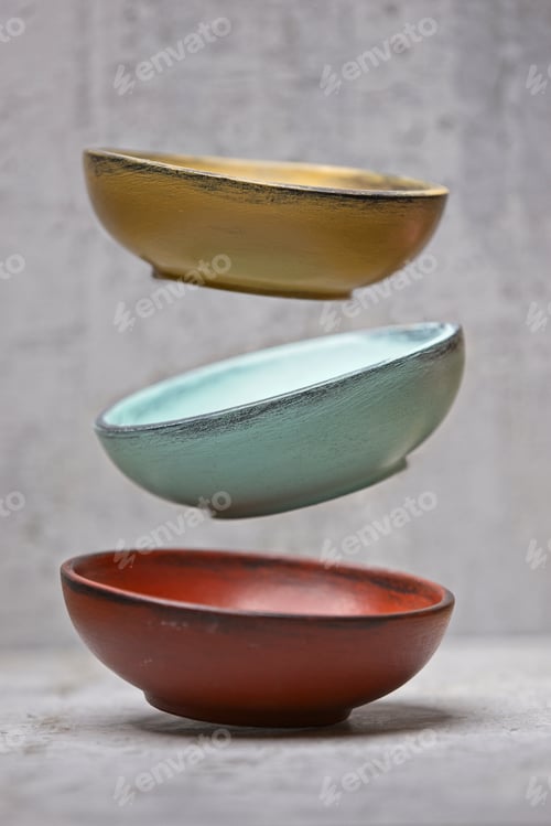Preview: Wooden bowls being dropped conceptual photo.