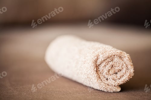 Preview: Towel on brown bed with copy space in living room.