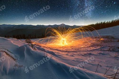 Preview: Light painting art. Spinning steel wool in abstract circle