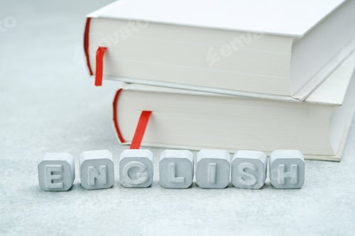 Preview: Word English made from gray concrete letters on a white book. English language studying