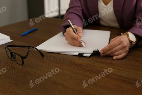Preview: Businesswoman working with documents at office table, closeup
