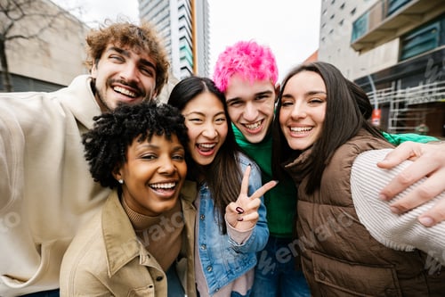 Preview: Young diverse friends taking group selfie on street