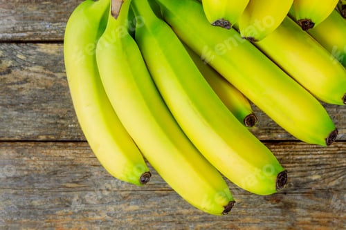 Preview: Fresh yellow bananas a bunch on wooden background