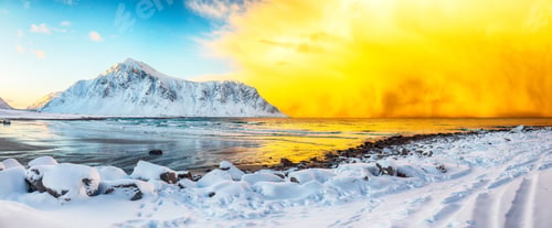 Preview: Amazing winter scenery on Skagsanden beach with illuminated clouds during sunrise