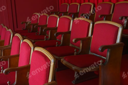 Preview: Empty rows of retro red theater or cinema seats with red upholstery