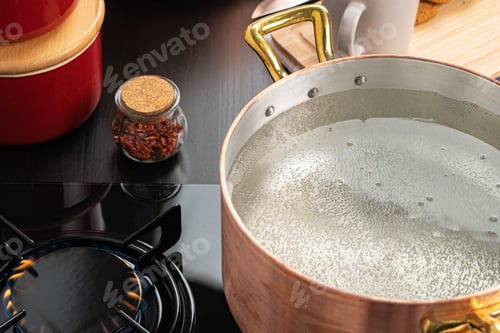 Preview: Copper pot with boiling water on a gas stove