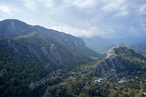 Preview: Alpine village in the valley surrounded by mountains.