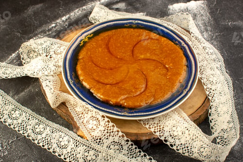 Preview: a top view sweet delicious halva yummy eastern sweet dessert inside plate on the dark background