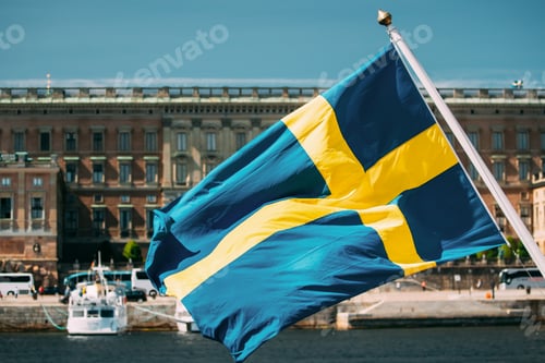 Preview: Stockholm, Sweden. Waving Swedish Flag In Stockholm Street. Stockholm, Sweden. Waving Swedish Flag