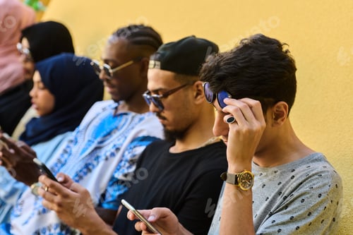 Preview: Diverse Teen Group Standing Together Against Wall Using Smartphones