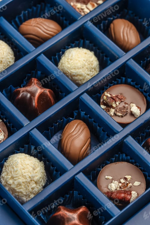 Preview: Luxury chocolate pralines assortment in blue gift box, close-up