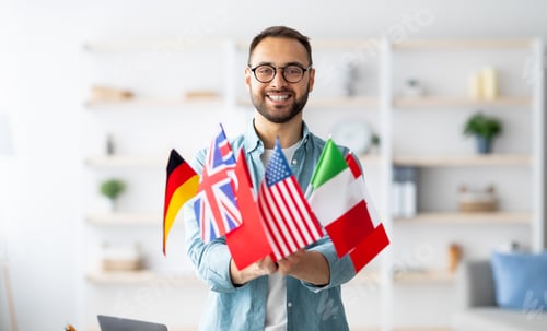 Preview: Modern education and student exchange. Cheerful young Caucasian guy holding bunch of different flags