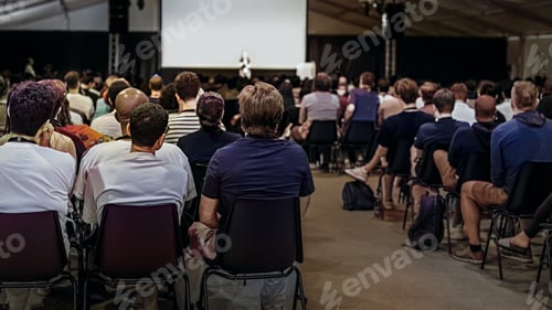 Preview: Group of people in hall or auditorium with screen