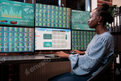 Preview: Hedge fund company professional employee sitting at multi monitor workstation