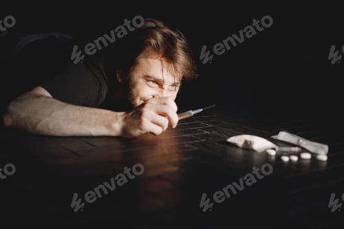 Preview: Junkie man reaches for syringe with dose
