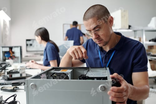 Preview: Technician Assembling Computer Hardware in Technology Lab