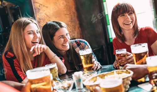 Preview: Happy women best friends drinking beer at vintage bar restaurant