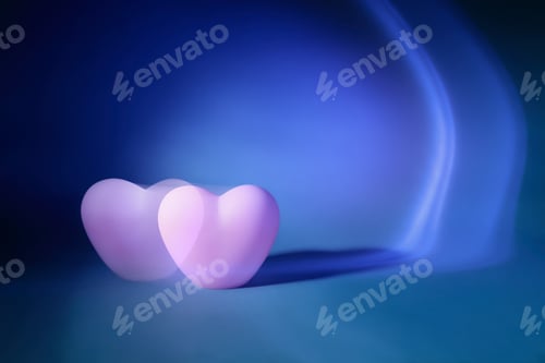 Preview: Abstract photography of defocused two pink heart making with long exposition on blue background.