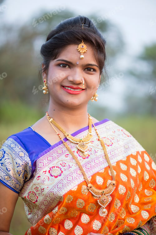 Preview: Beautiful Indian bride in traditional wedding dress at outdoor.