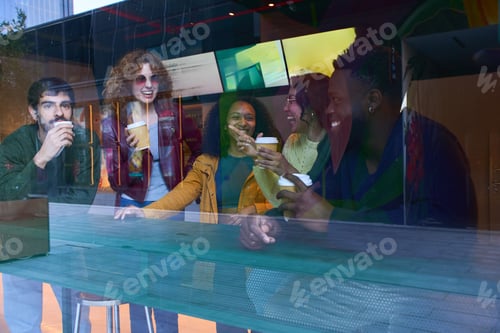 Preview: Cheerful multi ethnic friends drinking coffee and talking together at a bar