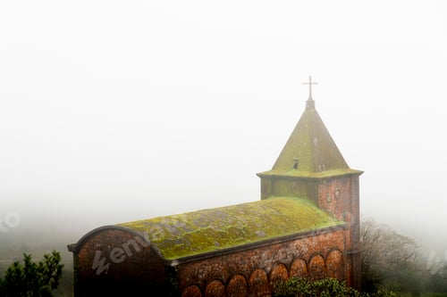 Preview: Aged mossy stone chapel in fog