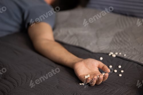 Preview: Young man sleeping near pills on bed in bedroom
