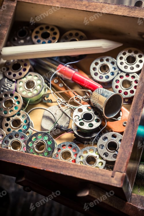 Preview: Closeup of tailor's wooden box with needles and threads