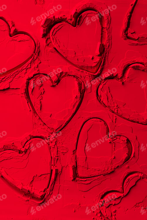 Preview: top view of shapes of cookie cutters in shape of hearts on red powder
