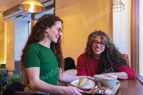 Preview: Lady serving breakfast to her friend in coffee shop