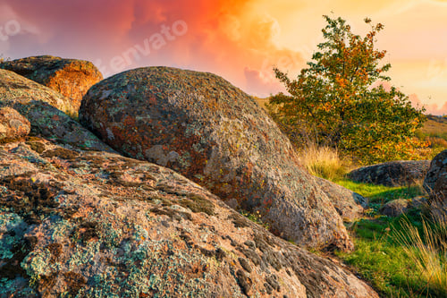 Preview: A small pile of stones in a green-yellow field against the background of a sky in Ukraine