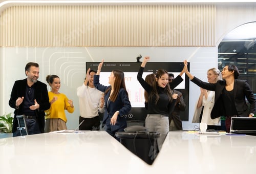 Preview: A group of multiracial businesspeople hands raise to celebrate success