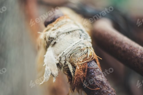 Preview: Old rags tied to a rusty metal