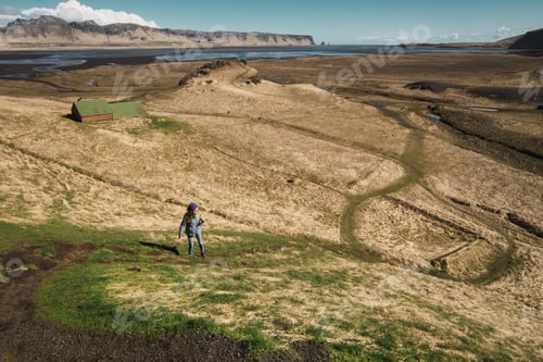 Preview: Woman standing on beautiful hills valley