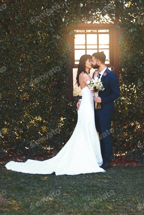 Affectionate Couple Kissing on Wedding Day in Garden