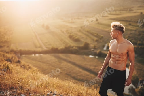 Preview: Muscular sportsman on natural background