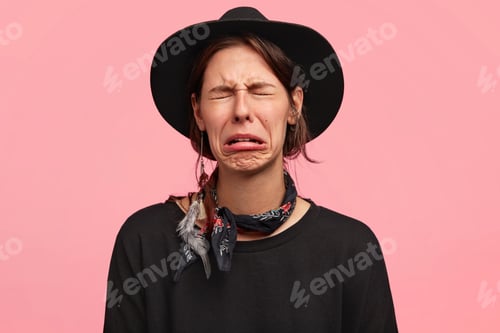 Preview: Desperate female farmer has sorrowful expression, cries as being tired after hard work in garden, we