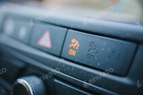 Preview: Closeup shot of a modern car's interior design with a button illuminated in yellow